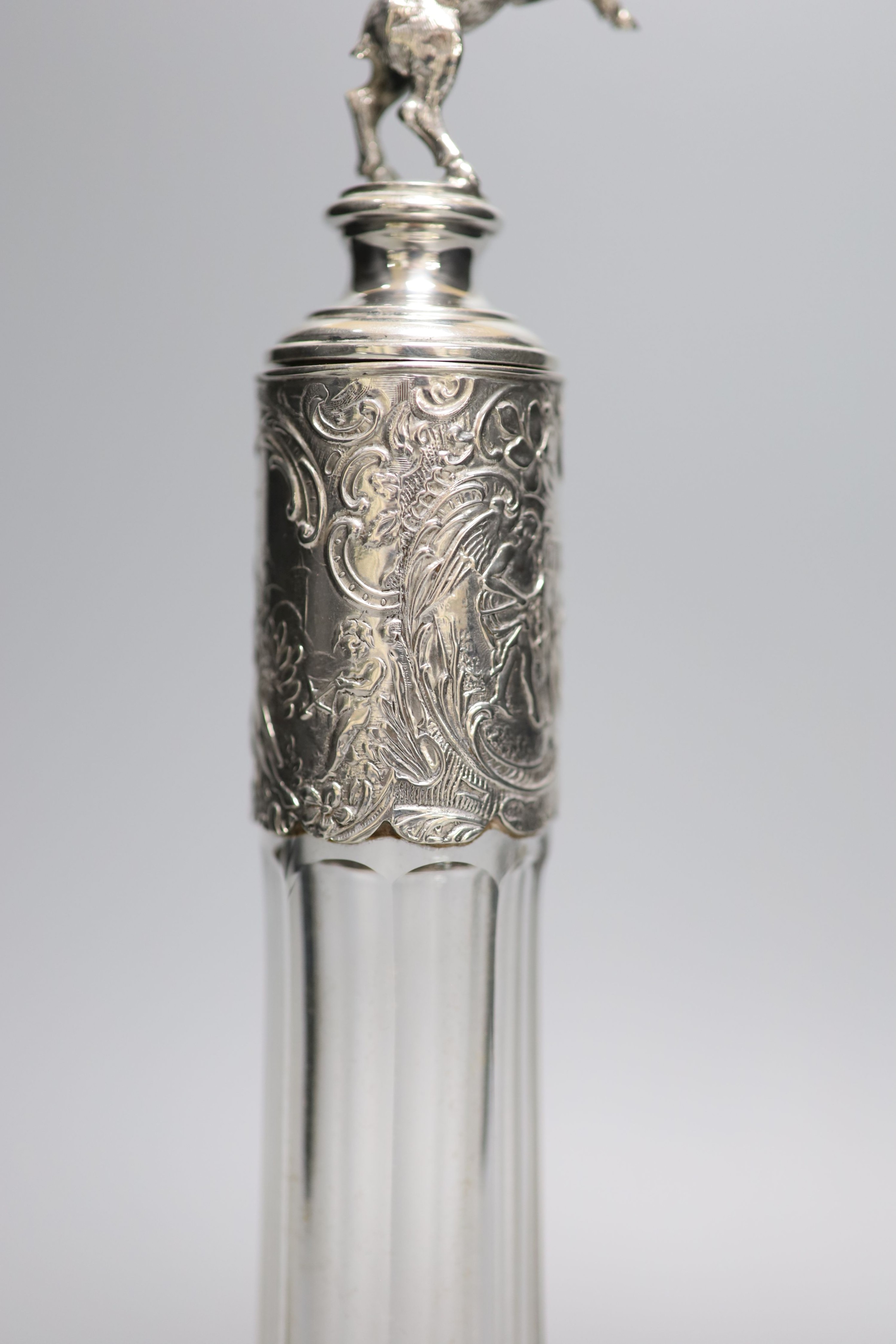 A late 19th/early 20th century Hanau? white metal mounted glass decanter, with rearing horse mounted stopper, 31.5cm